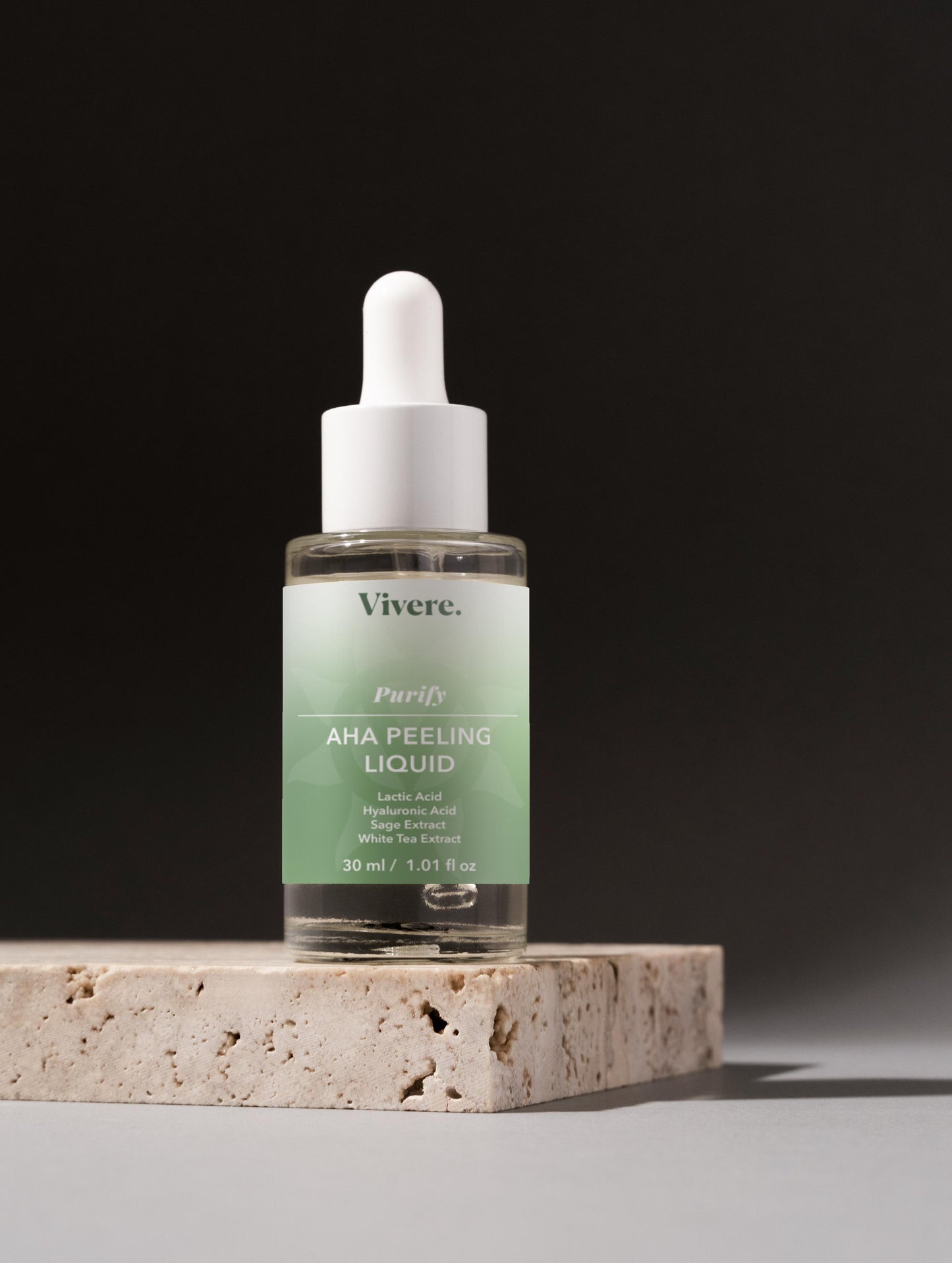 Vivere AHA Peeling Liquid bottle on a stone surface with a dark background