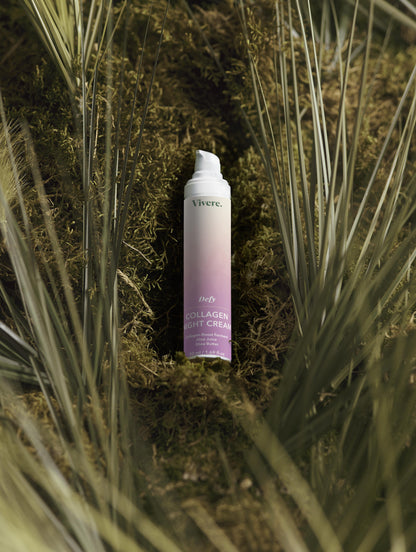 Collagen night cream bottle on a natural background with grass and moss